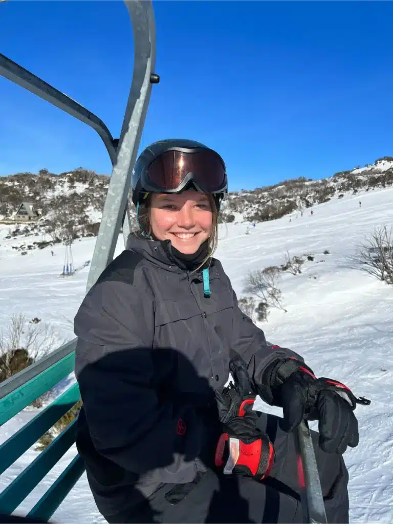 Bailey White, Client Experience Officer at Enhance Movement, smiling in the snow during a trip to Canada.